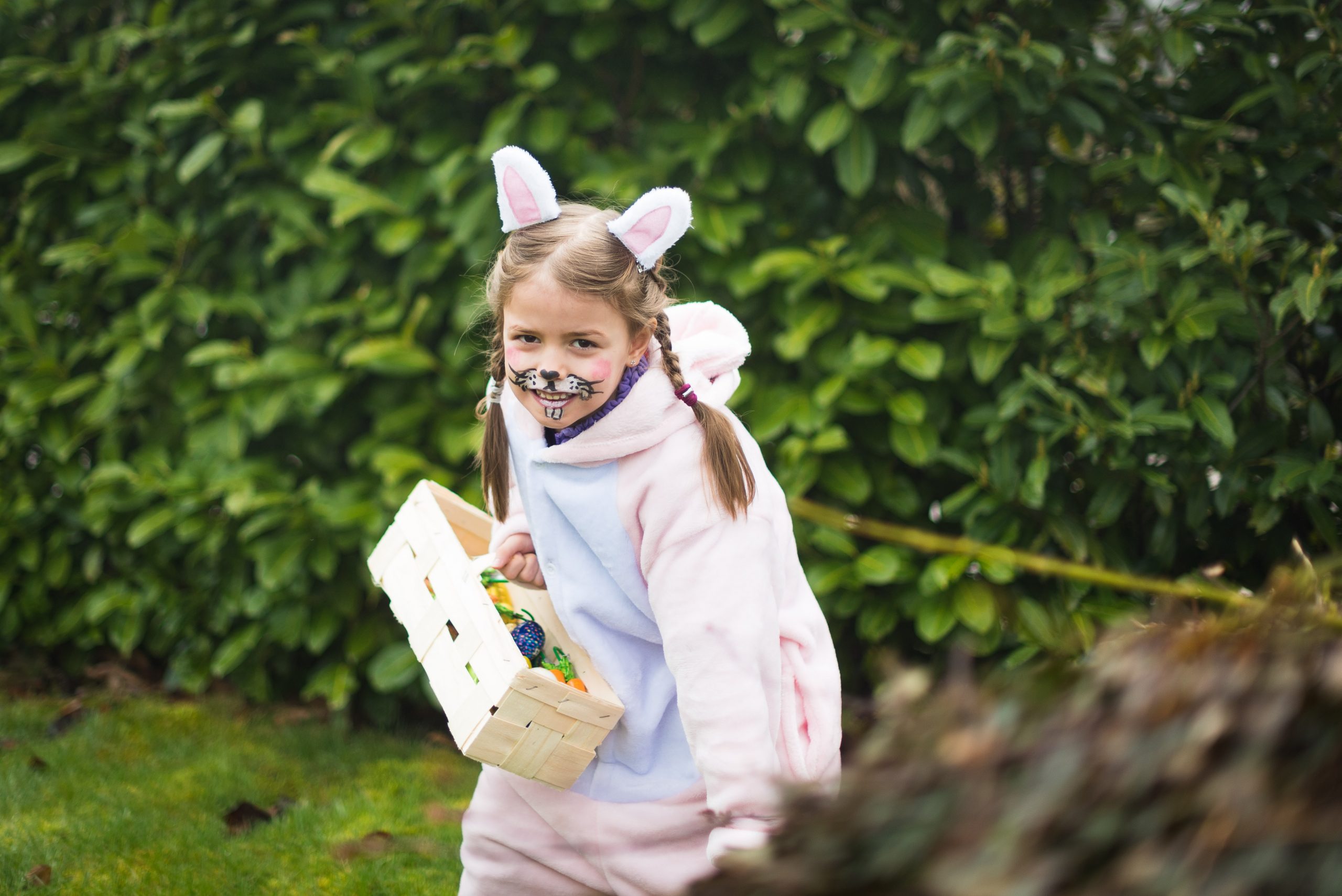 Young Girl Dressed as Bunny Easter Egg Hunting
